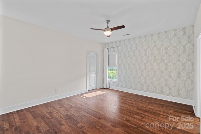 16909 Red Cow Rd, Charlotte, NC 28277 - spare room with wallpapered walls, dark wood-style floors, and a ceiling fan
