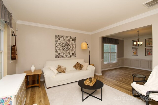 4001 Brook Valley Run, Monroe, NC 28110 - living area featuring crown molding, wood finished floors, and a chandelier