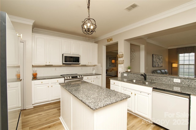 4001 Brook Valley Run, Monroe, NC 28110 - kitchen with white appliances, a sink, light wood-type flooring, dark stone counters, and ornamental molding