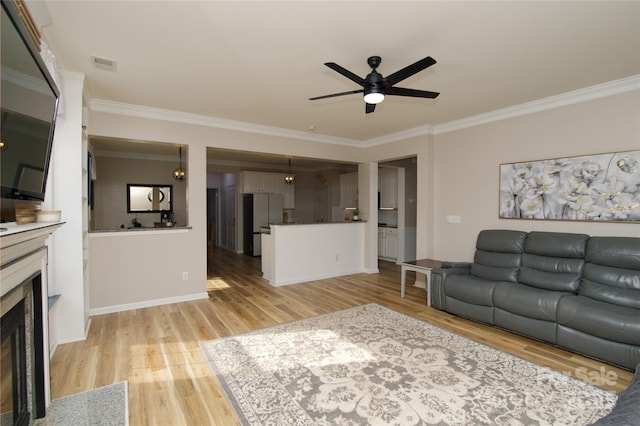 4001 Brook Valley Run, Monroe, NC 28110 - living room with ornamental molding, ceiling fan, light wood-type flooring, a fireplace with flush hearth, and baseboards