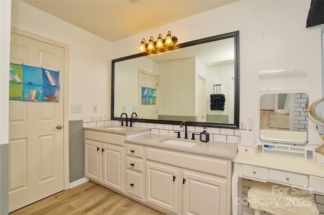 4001 Brook Valley Run, Monroe, NC 28110 - bathroom featuring double vanity, wood finished floors, and decorative backsplash