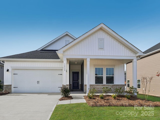 2119 Rolling Hills Ct, Stanley, NC 28164 - view of front of home with board and batten siding, concrete driveway, a garage, a porch, and a shingled roof