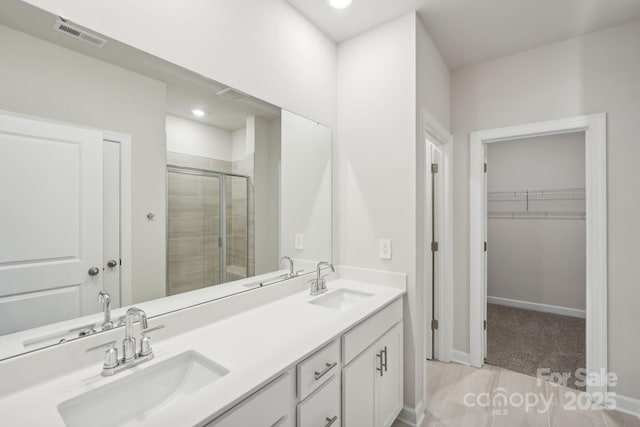2119 Rolling Hills Ct, Stanley, NC 28164 - full bath featuring a shower stall, double vanity, a walk in closet, and recessed lighting