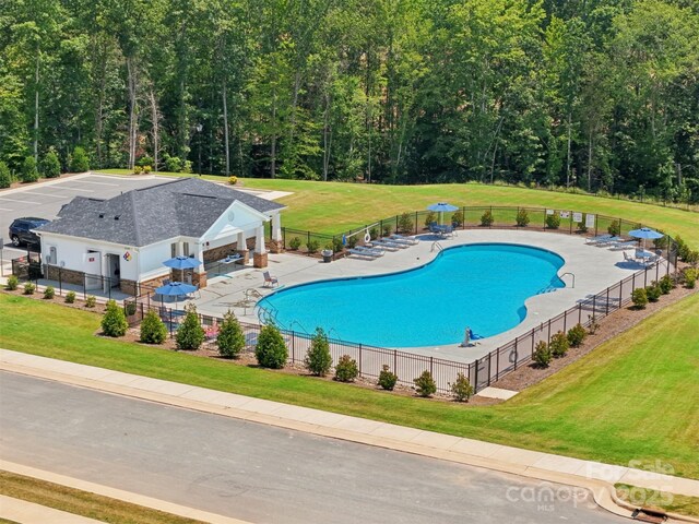 2119 Rolling Hills Ct, Stanley, NC 28164 - community pool featuring a patio area and a wooded view