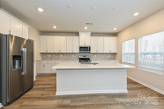 2123 Rolling Hills Ct, Stanley, NC 28164 - kitchen featuring stainless steel appliances, light countertops, decorative backsplash, and recessed lighting
