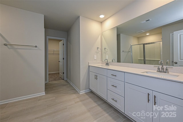 2123 Rolling Hills Ct, Stanley, NC 28164 - full bath with double vanity, a shower stall, a walk in closet, and recessed lighting