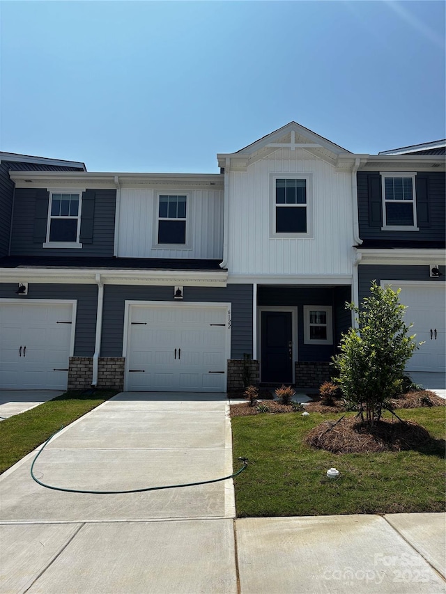 6122 Starview Ter, Charlotte, NC 28216 - view of front of home with an attached garage, driveway, a front yard, and brick siding