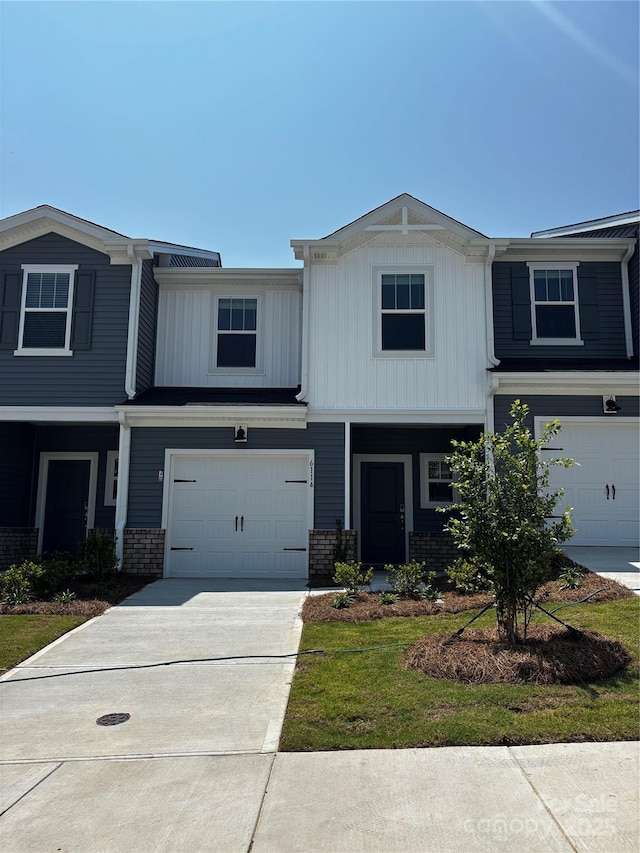 6114 Starview Ter, Charlotte, NC 28216 - view of front of home featuring brick siding, an attached garage, driveway, and board and batten siding