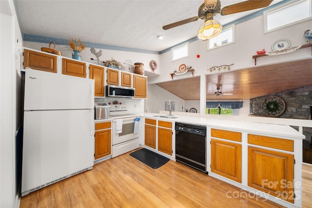 131 Apple Blossom Ln, Maggie Valley, NC 28751 - kitchen with white appliances, a ceiling fan, a peninsula, light countertops, and a sink