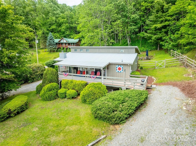 131 Apple Blossom Ln, Maggie Valley, NC 28751 - view of front facade featuring a view of trees, metal roof, driveway, and a wooden deck