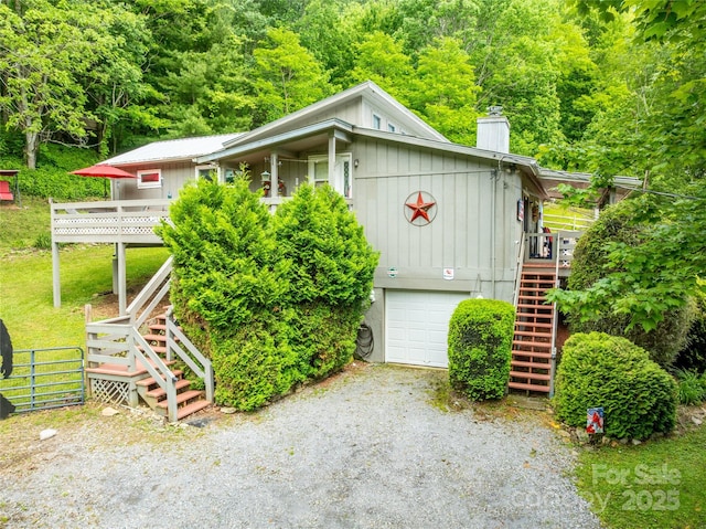 131 Apple Blossom Ln, Maggie Valley, NC 28751 - view of front of house with stairway, driveway, a garage, board and batten siding, and a deck