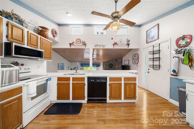 131 Apple Blossom Ln, Maggie Valley, NC 28751 - kitchen featuring stainless steel microwave, dishwasher, a sink, white range with electric cooktop, and a peninsula