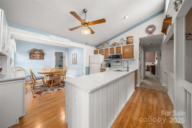 131 Apple Blossom Ln, Maggie Valley, NC 28751 - kitchen featuring white appliances, vaulted ceiling, ceiling fan, a sink, and light wood-style floors