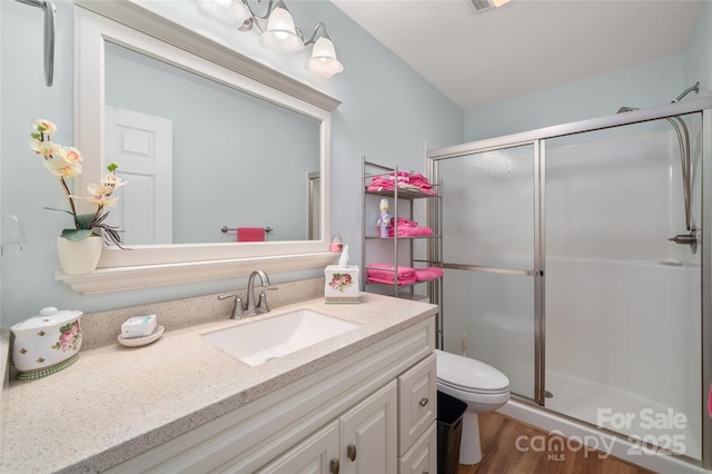 131 Apple Blossom Ln, Maggie Valley, NC 28751 - bathroom with a stall shower, vanity, toilet, and wood finished floors