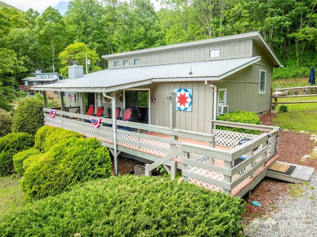 131 Apple Blossom Ln, Maggie Valley, NC 28751 - view of front of house featuring metal roof, a chimney, a forest view, and cooling unit