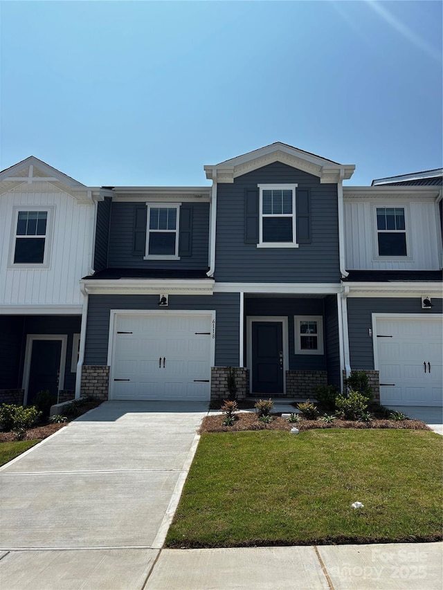6118 Starview Ter, Charlotte, NC 28216 - view of front of property featuring an attached garage, a front yard, driveway, and board and batten siding