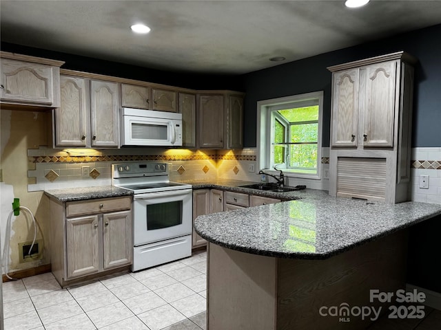 103 Sycamore Rd, Salisbury, NC 28147 - kitchen featuring white appliances, a sink, a peninsula, dark stone counters, and backsplash