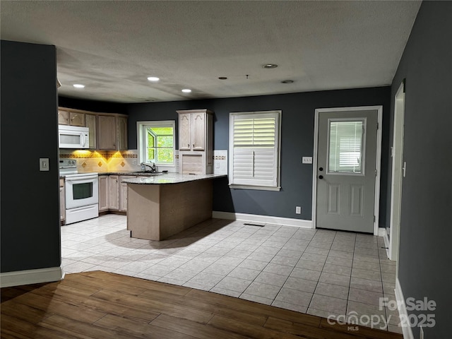 103 Sycamore Rd, Salisbury, NC 28147 - kitchen featuring white appliances, a peninsula, a sink, tasteful backsplash, and a textured ceiling