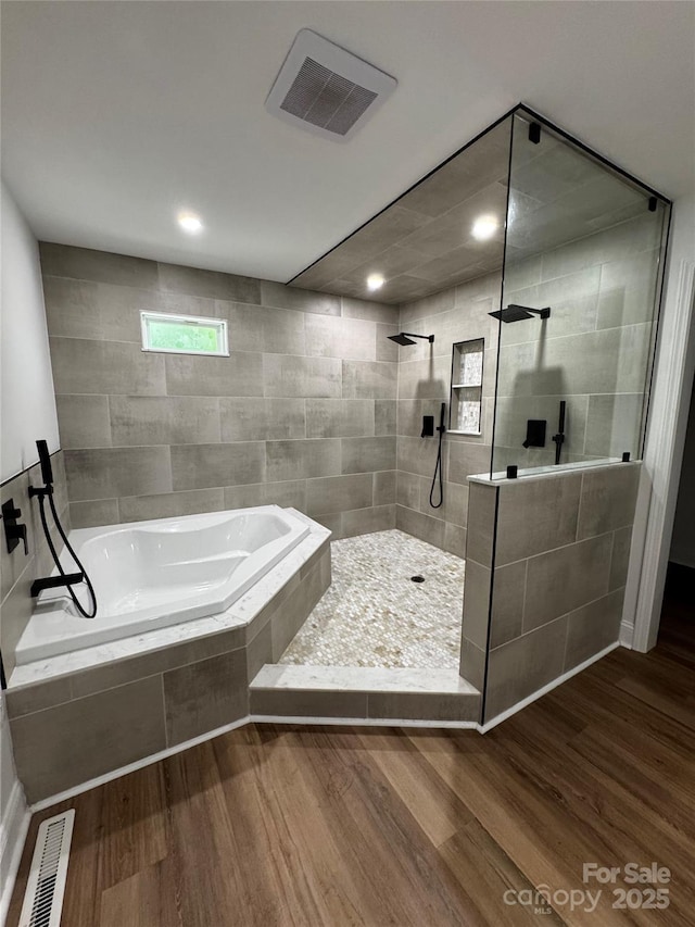 103 Sycamore Rd, Salisbury, NC 28147 - bathroom with wood finished floors, a garden tub, walk in shower, and recessed lighting