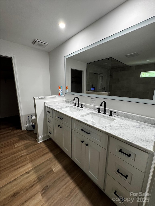 103 Sycamore Rd, Salisbury, NC 28147 - full bathroom featuring double vanity, wood finished floors, toilet, tiled shower, and recessed lighting