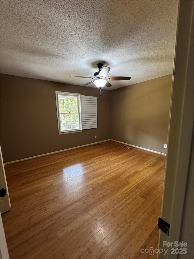103 Sycamore Rd, Salisbury, NC 28147 - unfurnished room with ceiling fan, wood finished floors, a textured ceiling, and baseboards