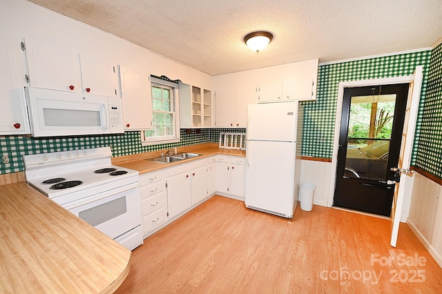 2625 Glenn St, Newton, NC 28658 - kitchen featuring white appliances, a textured ceiling, wallpapered walls, light countertops, and light wood-type flooring