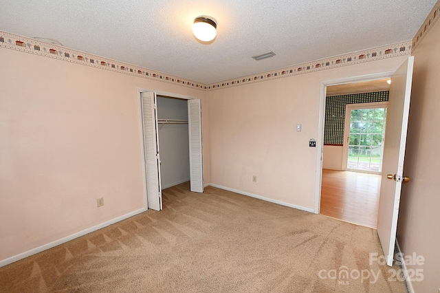 2625 Glenn St, Newton, NC 28658 - unfurnished bedroom with a textured ceiling, carpet flooring, baseboards, and a closet