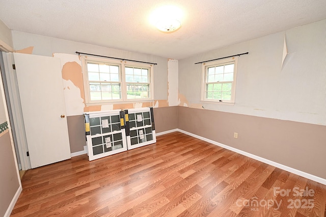 2625 Glenn St, Newton, NC 28658 - spare room with wood finished floors, a textured ceiling, and baseboards