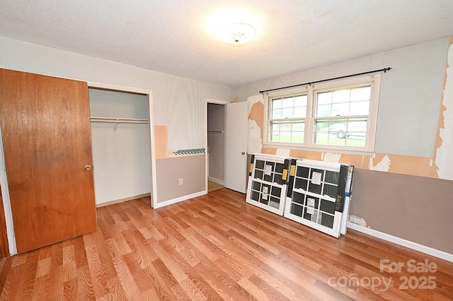 2625 Glenn St, Newton, NC 28658 - unfurnished bedroom with a closet, wood finished floors, a textured ceiling, and baseboards