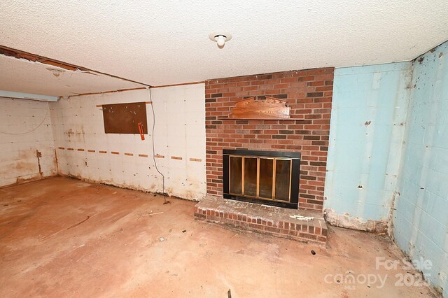 2625 Glenn St, Newton, NC 28658 - unfurnished living room featuring a fireplace, concrete block wall, and a textured ceiling