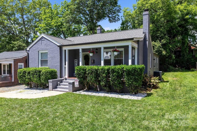 432 4th Street Pl SW, Hickory, NC 28602 - view of front facade with a front yard, a chimney, central AC unit, and brick siding