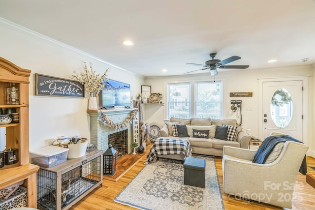 432 4th Street Pl SW, Hickory, NC 28602 - living room with ornamental molding, wood finished floors, a ceiling fan, a fireplace, and recessed lighting