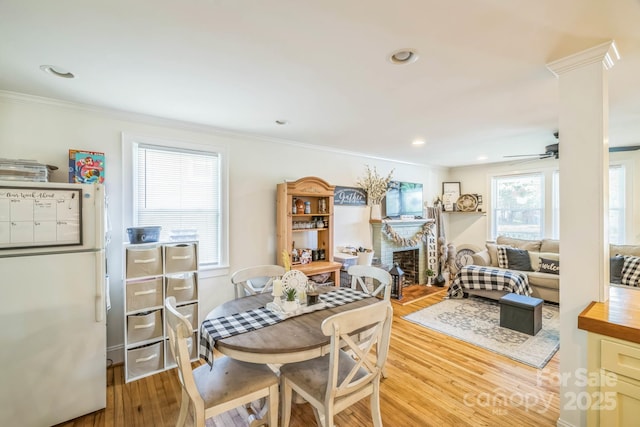 432 4th Street Pl SW, Hickory, NC 28602 - dining space featuring light wood-type flooring, ornamental molding, a fireplace, ceiling fan, and recessed lighting