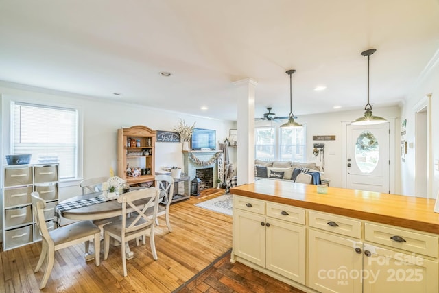 432 4th Street Pl SW, Hickory, NC 28602 - kitchen featuring wood counters, a fireplace, crown molding, pendant lighting, and light wood finished floors