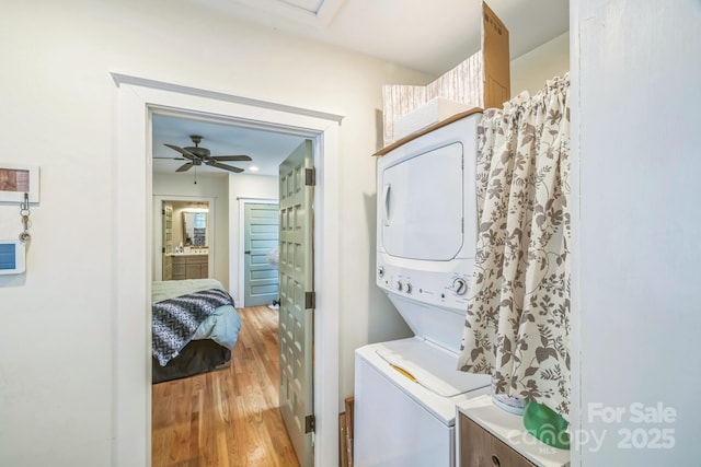 432 4th Street Pl SW, Hickory, NC 28602 - washroom featuring stacked washing machine and dryer, light wood-type flooring, and a ceiling fan