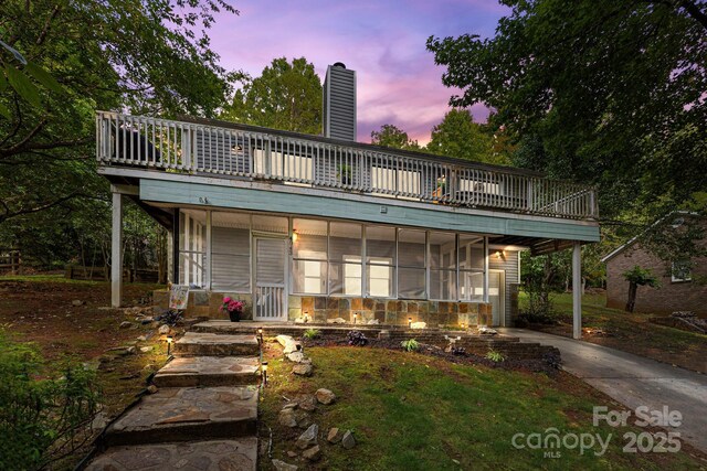 4043 Windward Dr, Tega Cay, SC 29708 - view of front of property with a chimney, a sunroom, driveway, and a wooden deck