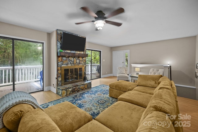 4043 Windward Dr, Tega Cay, SC 29708 - living room featuring a ceiling fan, wood finished floors, a fireplace, and baseboards