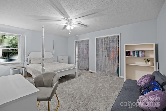 4043 Windward Dr, Tega Cay, SC 29708 - carpeted bedroom with multiple closets, a ceiling fan, a textured ceiling, and baseboards