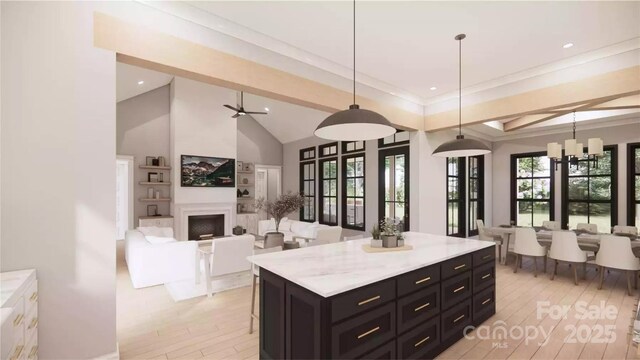 0000 Woodhill Cove Ln Unit 5, Denver, NC 28037 - kitchen featuring light countertops, hanging light fixtures, open floor plan, dark cabinets, and a fireplace