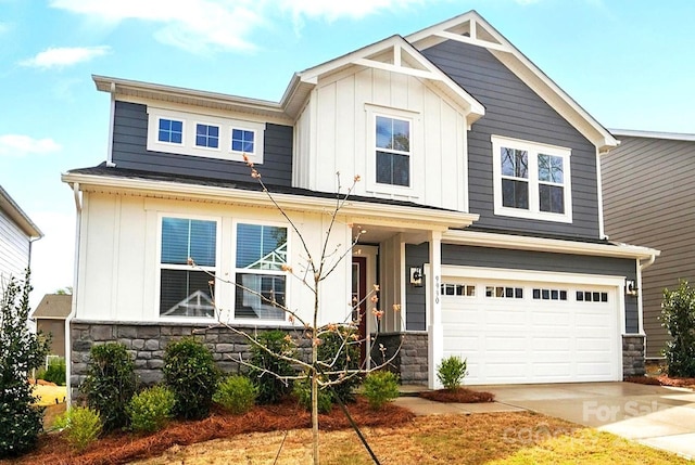 9930 Cask Way, Huntersville, NC 28078 - view of front of house with board and batten siding, stone siding, an attached garage, and driveway