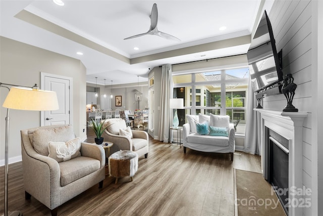 1712 Askern Ct, Waxhaw, NC 28173 - living area featuring crown molding, wood finished floors, ceiling fan, recessed lighting, and a fireplace with flush hearth