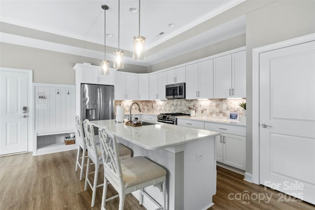 1712 Askern Ct, Waxhaw, NC 28173 - kitchen featuring stainless steel appliances, a sink, ornamental molding, a kitchen bar, and decorative backsplash