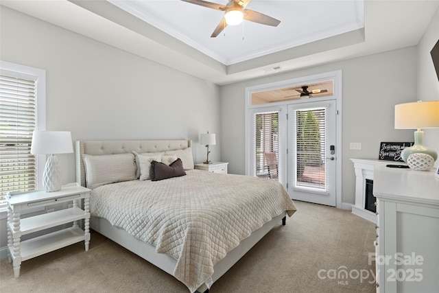 1712 Askern Ct, Waxhaw, NC 28173 - bedroom featuring light colored carpet, access to outside, crown molding, a fireplace, and a tray ceiling