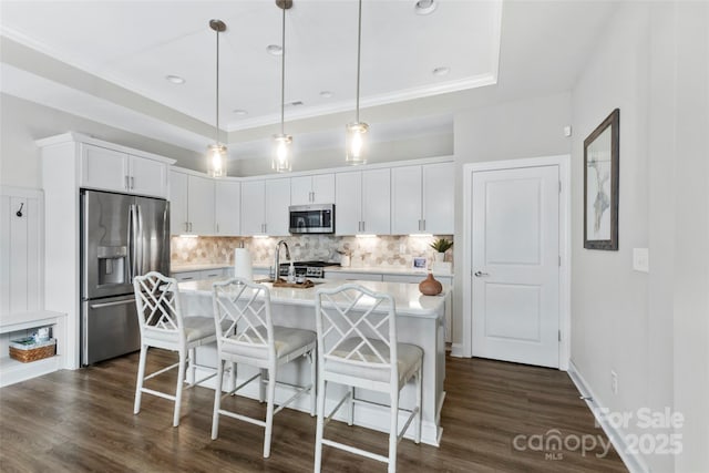 1712 Askern Ct, Waxhaw, NC 28173 - kitchen with appliances with stainless steel finishes, light countertops, decorative backsplash, a kitchen breakfast bar, and white cabinetry