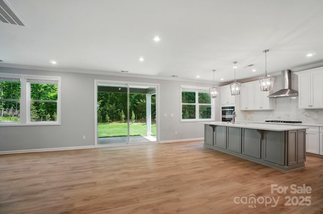 9957 Cask Way, Huntersville, NC 28078 - kitchen with wall chimney range hood, light countertops, white gas cooktop, baseboards, and recessed lighting