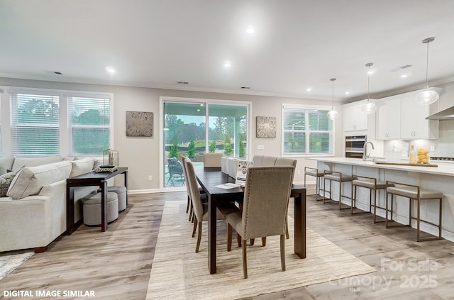 9957 Cask Way, Huntersville, NC 28078 - dining space featuring light wood-style flooring, healthy amount of natural light, ornamental molding, baseboards, and recessed lighting