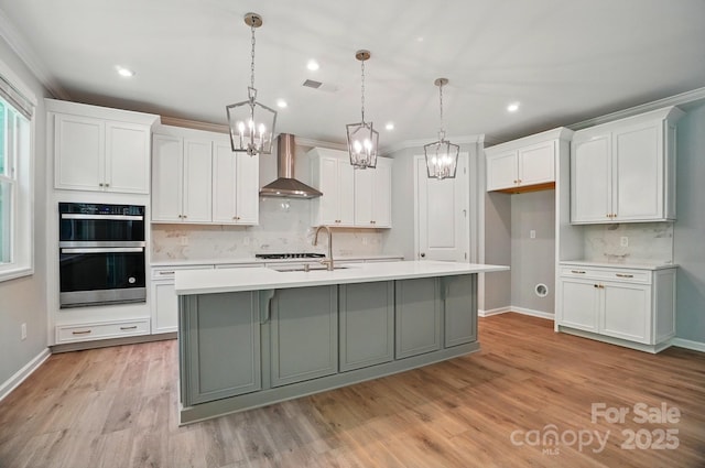 9957 Cask Way, Huntersville, NC 28078 - kitchen with wall chimney exhaust hood, double oven, a sink, a chandelier, and recessed lighting