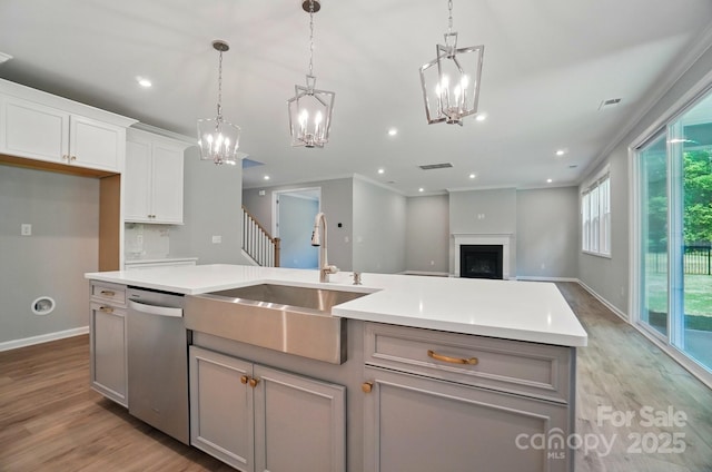 9957 Cask Way, Huntersville, NC 28078 - kitchen with stainless steel dishwasher, a sink, a chandelier, light wood-type flooring, and recessed lighting