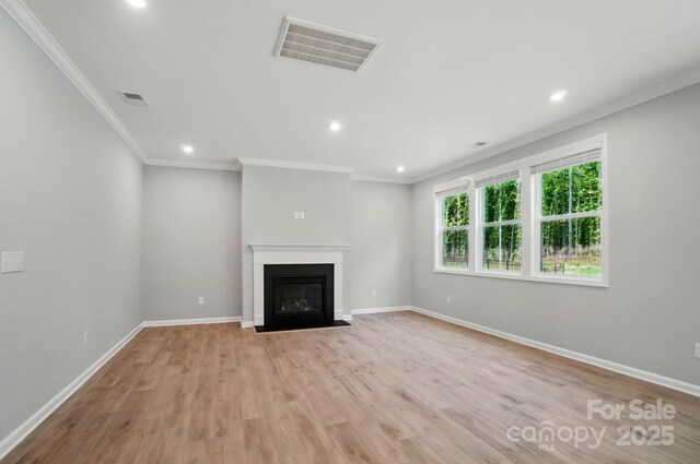 9957 Cask Way, Huntersville, NC 28078 - unfurnished living room featuring crown molding, light wood-style flooring, baseboards, recessed lighting, and a fireplace with flush hearth