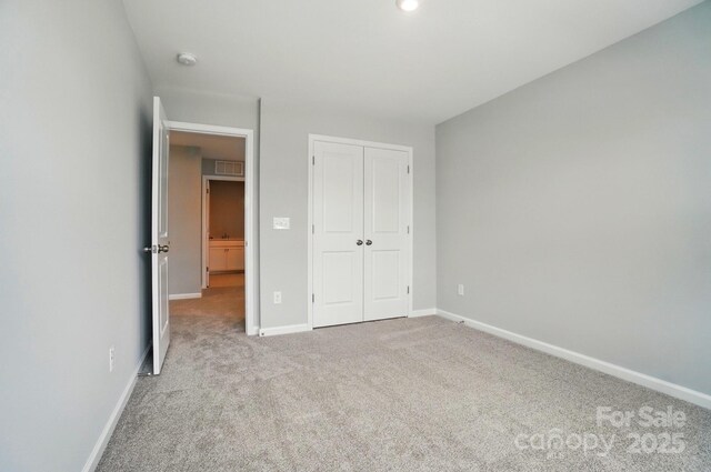 9957 Cask Way, Huntersville, NC 28078 - unfurnished bedroom with carpet flooring, baseboards, and a closet